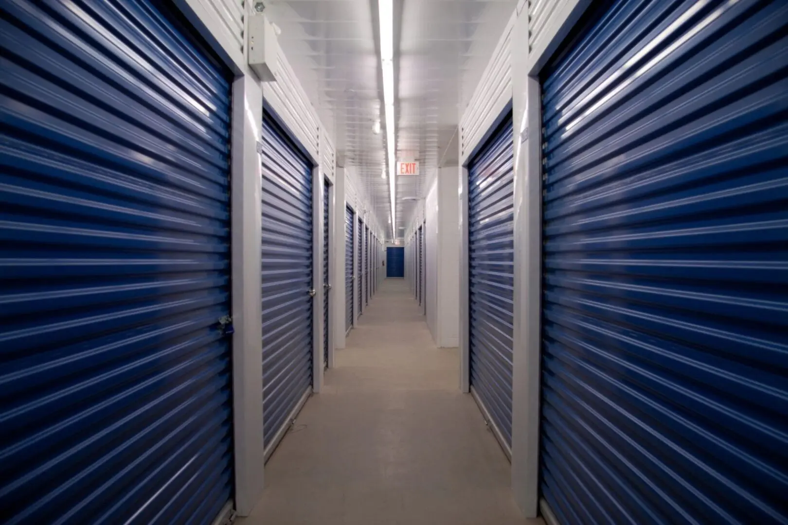 A long hallway with many blue doors